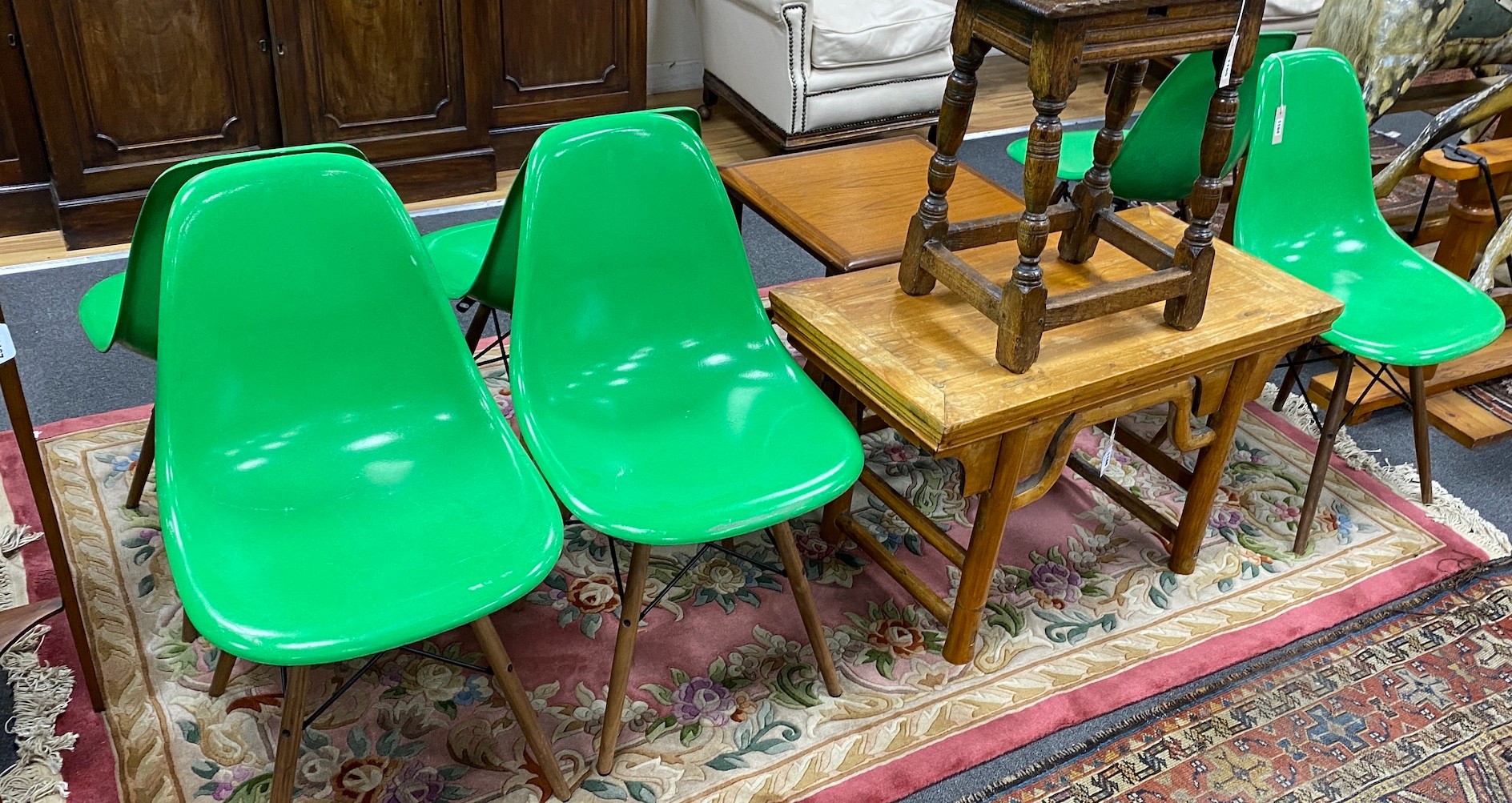 A set of six green Eames chairs